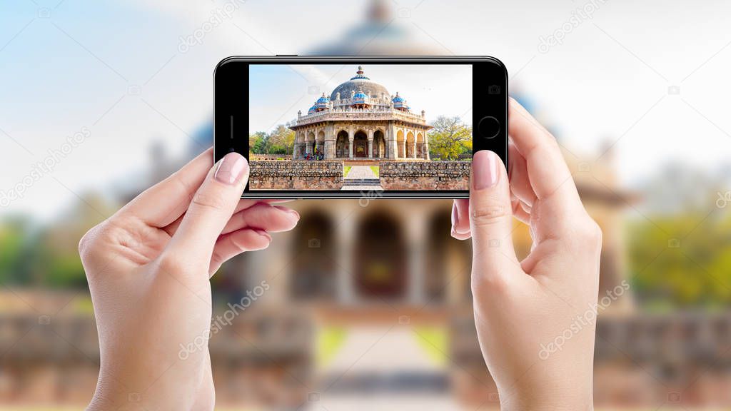Taking a photo with mobil phone of Humayuns tomb, Top sights of New Delhi, India