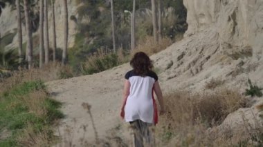 Calafia Park San Clemente California 'da yaya yolunda yürüyen aktif kıdemli bir kadın.