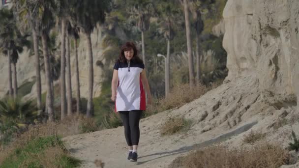 Active Senior woman walking at pedestrian trail Calafia Park San Clemente California 01.01.2020 — Stock Video