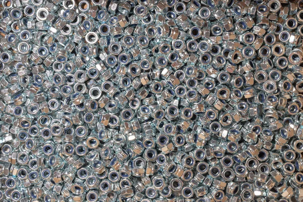 Nuts. Texture. A lot of rubberized nuts for bolts and screws. Background for wallpaper. Female screw. Screw-nut. Internal screw.