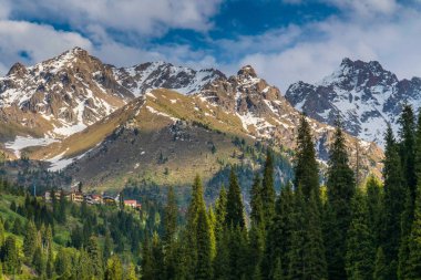 Önünde orman olan dağlar. Dağlardaki köy..