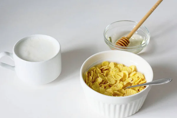 Healthy breakfast with cornflakes and milk over white background — Stock Photo, Image