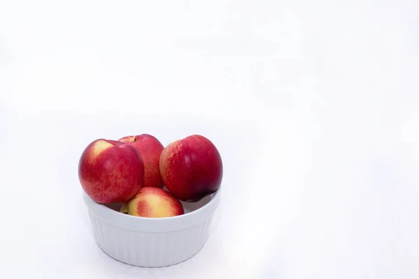 Group of whole nectarine fruits isolated on white background — Stock Photo, Image