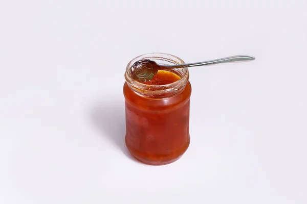 Glass jar of jam on a dark background — Stock Photo, Image