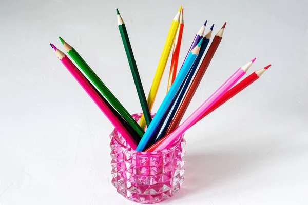 Many colored pencils lie on a white background. Copy spase. The concept of back to school, the educational process, study at school, drawing — Stock Photo, Image