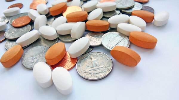 Таблетки, таблетки и капсулы с американскими монетами на долларовом фоне США. Аптека и деньги тема, здравоохранение, рецепт лекарств для лечения лекарств
