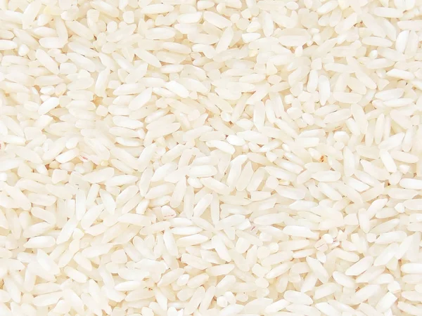 Light food texture background with small long asian white rice