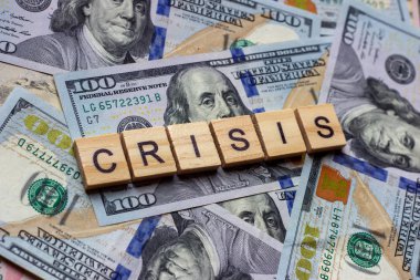 The word crisis on dollar usa background. Crash, bankruptcy and failure concept.