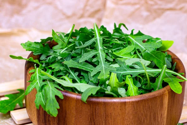 Fresh Green Spicy Arugula Salad Leaves Brown Wooden Bowl Light — Stock Photo, Image
