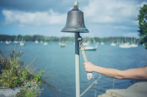 Young Woman Ringing Bell River Call Boatman — Stock Photo, Image