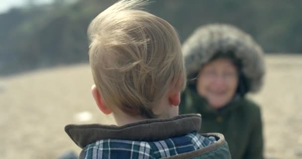 Little Boy Beach Looking His Grandmother — Stock Video