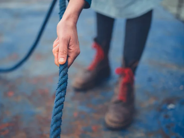 Una Joven Está Pie Embarcadero Está Tirando Una Cuerda —  Fotos de Stock