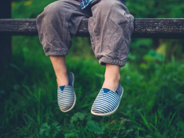 Fötterna Ett Litet Barn Sitter Bänk Naturen — Stockfoto