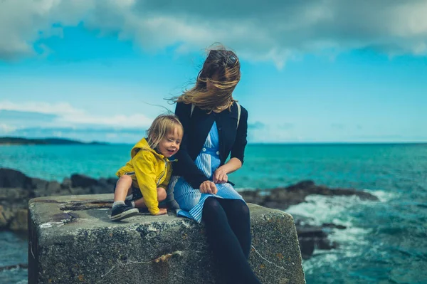 Jeune Mère Tout Petit Assis Sur Bloc Béton Par Mer — Photo