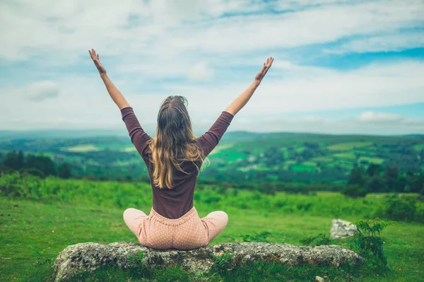 Young Woman Sitting Rock Nature Raising Arms — Stock Photo, Image