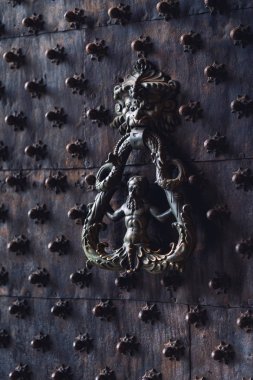 Black metallic Italian style door knocker in Genoa, Italy clipart