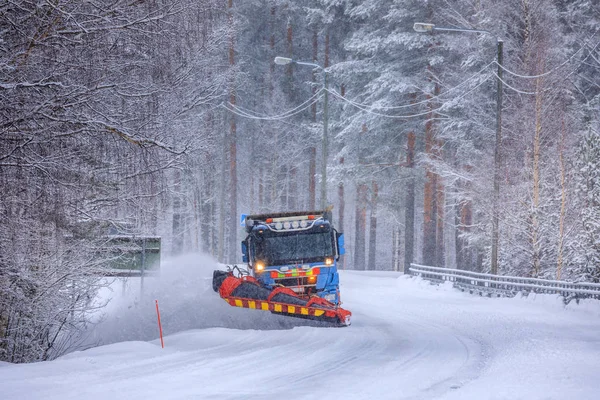 Snowplow caminhão limpando uma estrada gelada coberta de neve Imagens Royalty-Free