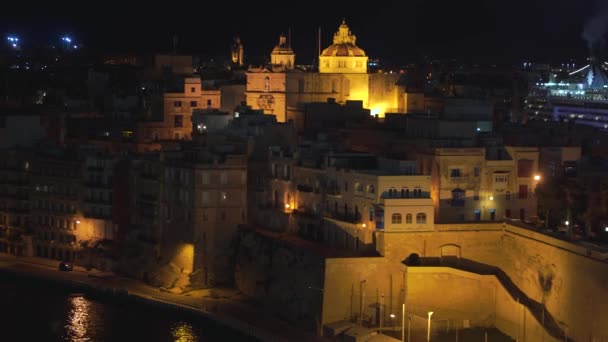 Vista panorámica nocturna de una línea costera y el centro de La Valeta, Malta con diferentes puntos de referencia de la ciudad en 4k — Vídeo de stock