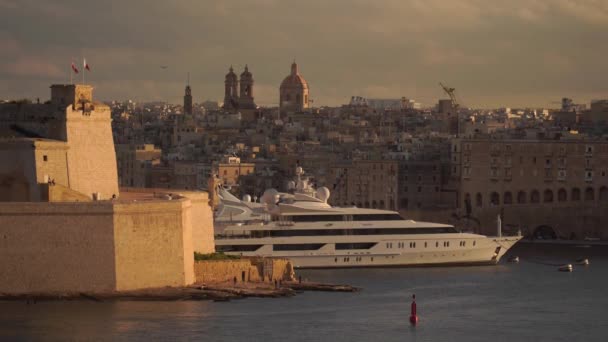 Valletta, Malta-12. listopadu 2018-luxusní výletní loď v přístavu města s panoramatickým výhledem na staré starověké zdi v 4k — Stock video