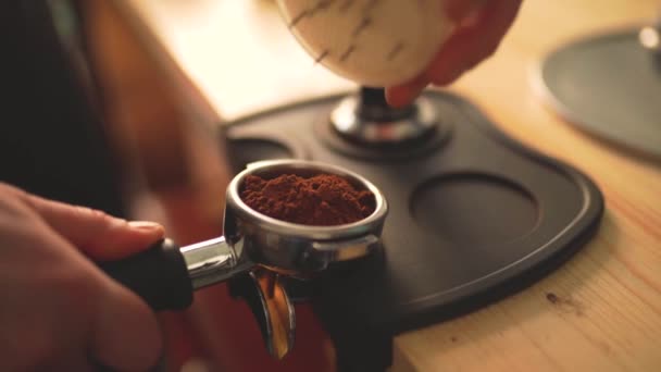 Rallentamento del processo di produzione del caffè passo dopo passo. Barista mani premendo chicchi di caffè appena macinati — Video Stock