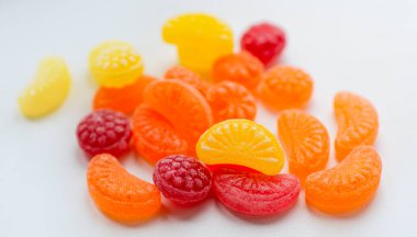 Beyaz arka planda izole edilmiş küçük meyve renkli tatlı lolipoplar.