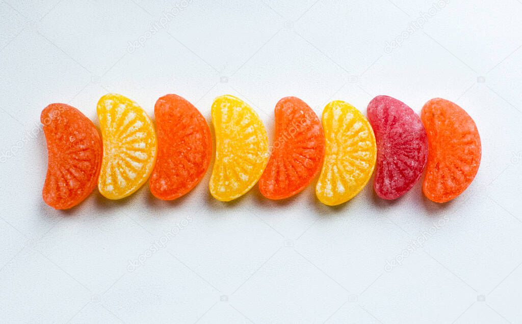 little fruit colored sweet lollipops isolated on white background