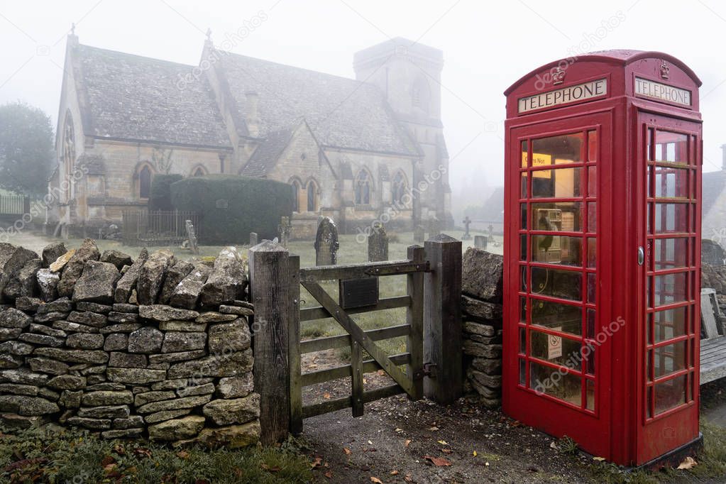 Telephone box near Snowshill church in theCotswolds. Misty landscape