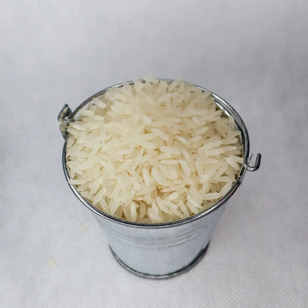 Beyaz uzun taneli pirinç bir minyatür metal kova