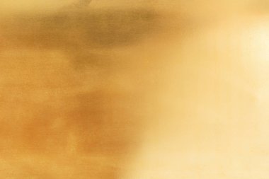 Altın arka arka plan veya doku pürüzsüz ve degradeler gölge. Yumuşak odak.