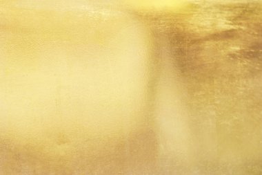 Altın arka arka plan veya doku pürüzsüz ve degradeler gölge. Yumuşak odak.