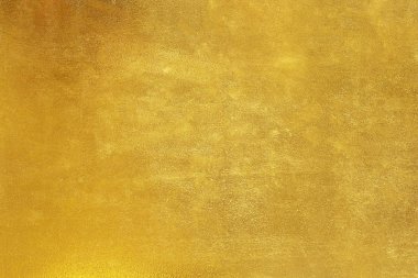 Parlak sarı yaprak altın folyo dokusu arka plan.