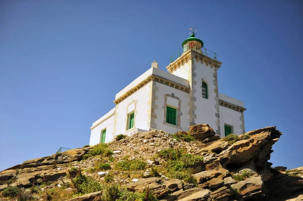 Beautiful white stone lighthouse on the rock, Paros island, Greece