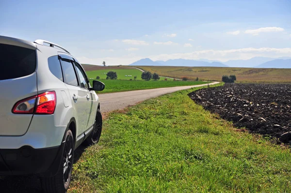 White car moving by the rural road, Slovakia