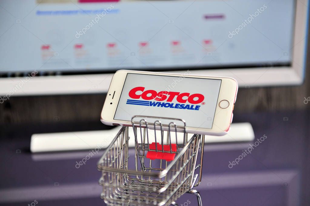 YAROSLAVL, RUSSIA - AUGUST 13, 2019: Costco Wholesale logo in mobile phone in shopping cart.
