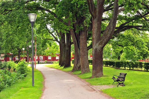 Peaceful path in city park of Orebro on summer