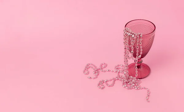 Склянка Візерунком Пастельному Рожевому Фоні Бісер Висить Краю Чашки Частково — стокове фото