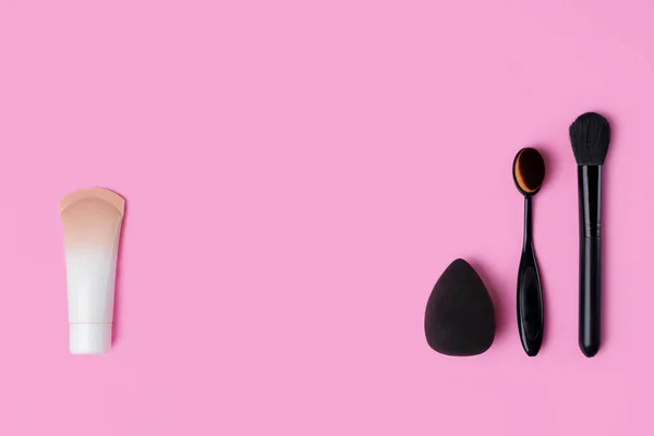 Cosmetics and accessories on a pink background. flat lay