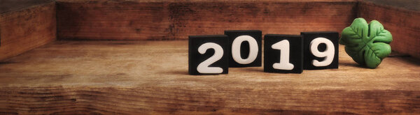 wooden background of the new year 2019 with shamrock