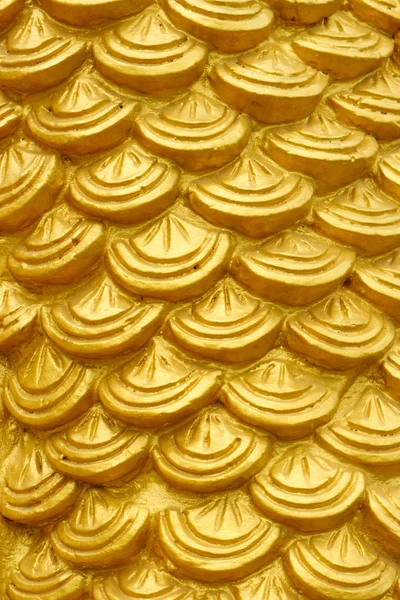 golden cement plaster in fish skin curve pattern texture wall background.