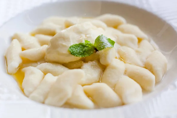 Lazy dumplings - vareniki of cottage cheese on a white plate, close up on a white plate.