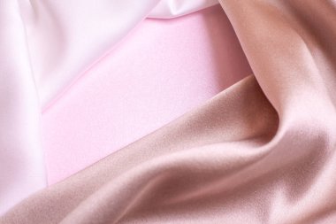Pembe inci kağıtta yumuşak ipek kumaşların soyut arkaplanı. Güzel eğilim dokusu.