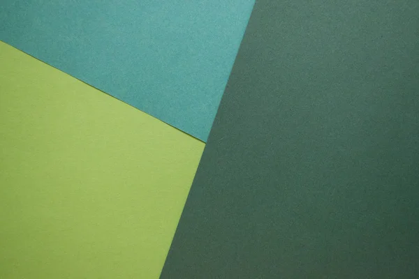 background of colored paper, green rolls