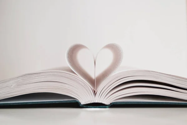 pages of a book curved into heart shape