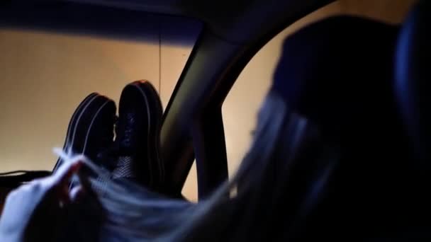 une jeune fille dans la voiture a jeté ses jambes sur le panneau 