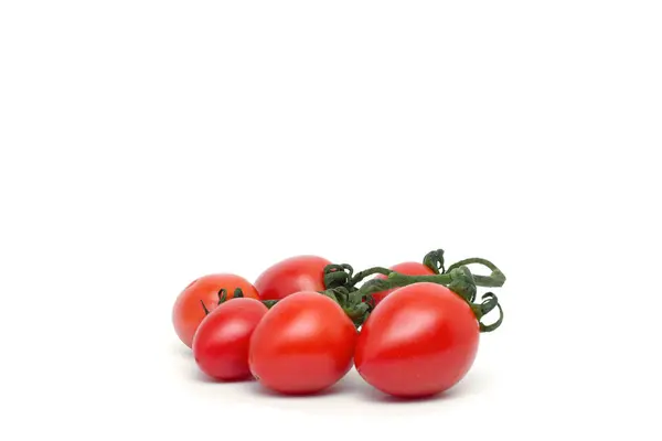 Close-up view the small fresh tomatoes isolated on a white background with a natural shadow. — Stock Photo, Image
