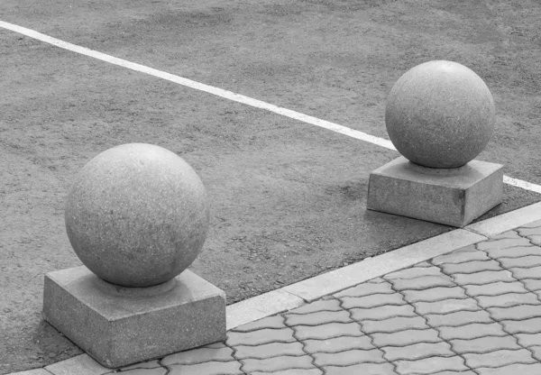 Stone spheres on the sidewalk. Stone blocks. Elements of city architecture