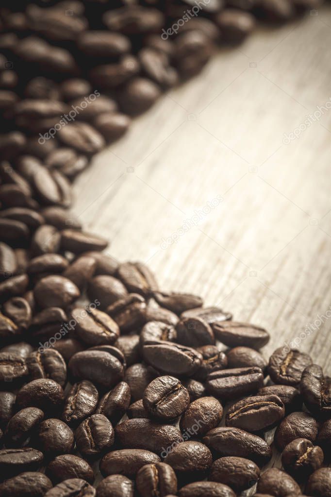 Close-up of coffee beans on wooden background