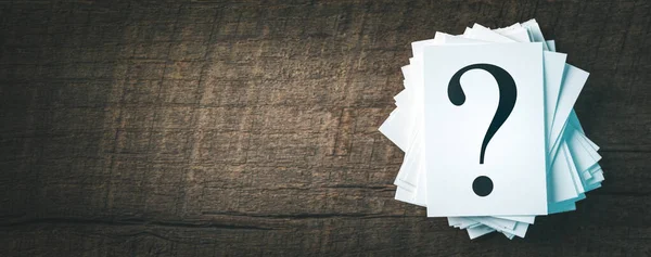 Stack Of Papers With Question Marks On Wooden Table - Decisions Concept