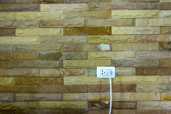 Brick wall background with plugs