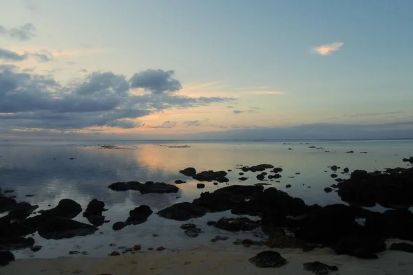 The sparkling ocean at sunset in Grand Baie, Mauritius